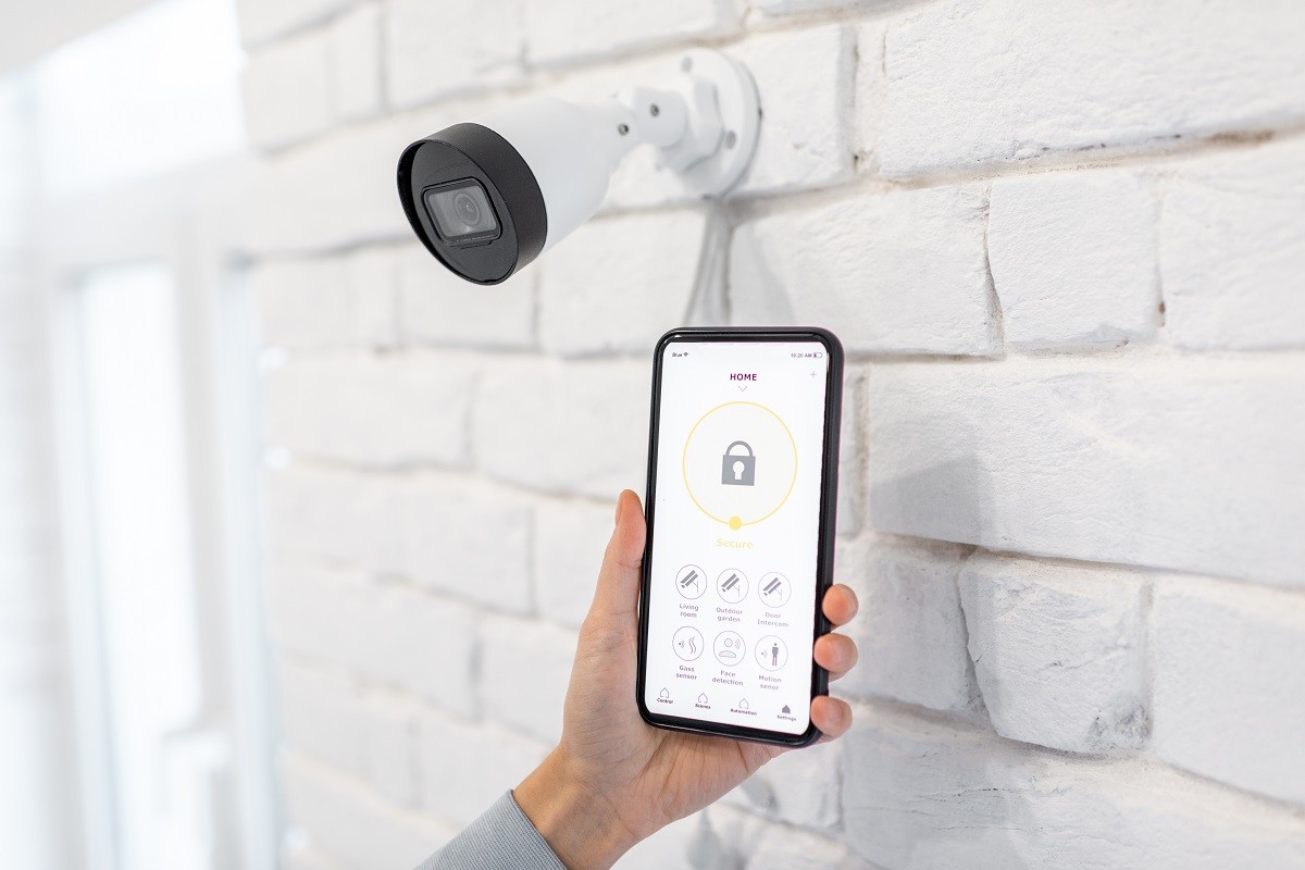 a homeowner testing their app and smart camera connection