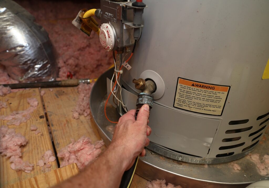 an appliance expert inspecting a hot water heater