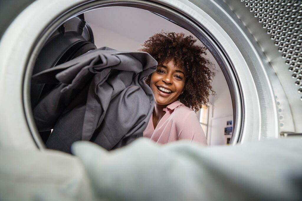 a woman pulling clothes out of her dryer