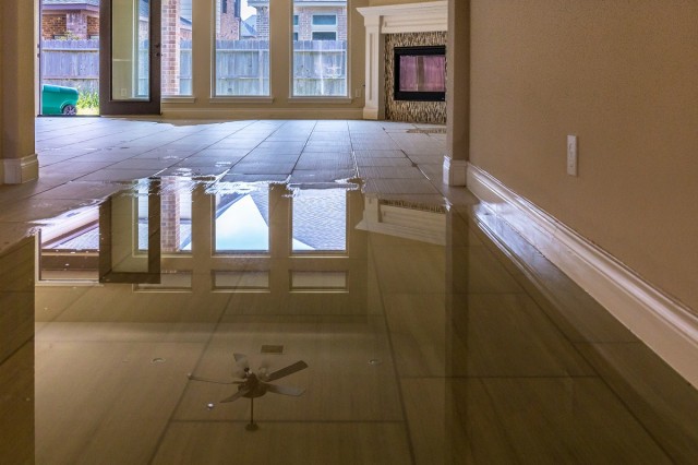 a large puddle spreading across a kitchen floor