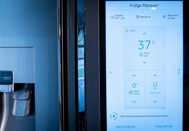 a screen on the front of a refrigerator shows it is currently 37 degrees