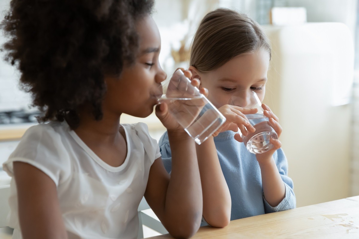 Two children drinking glasses of water - Consumer Confidence Report