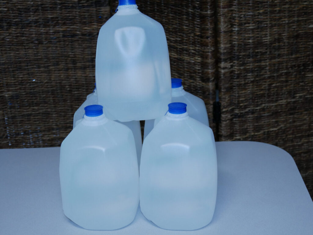 4 water jugs with another one stacked on the top