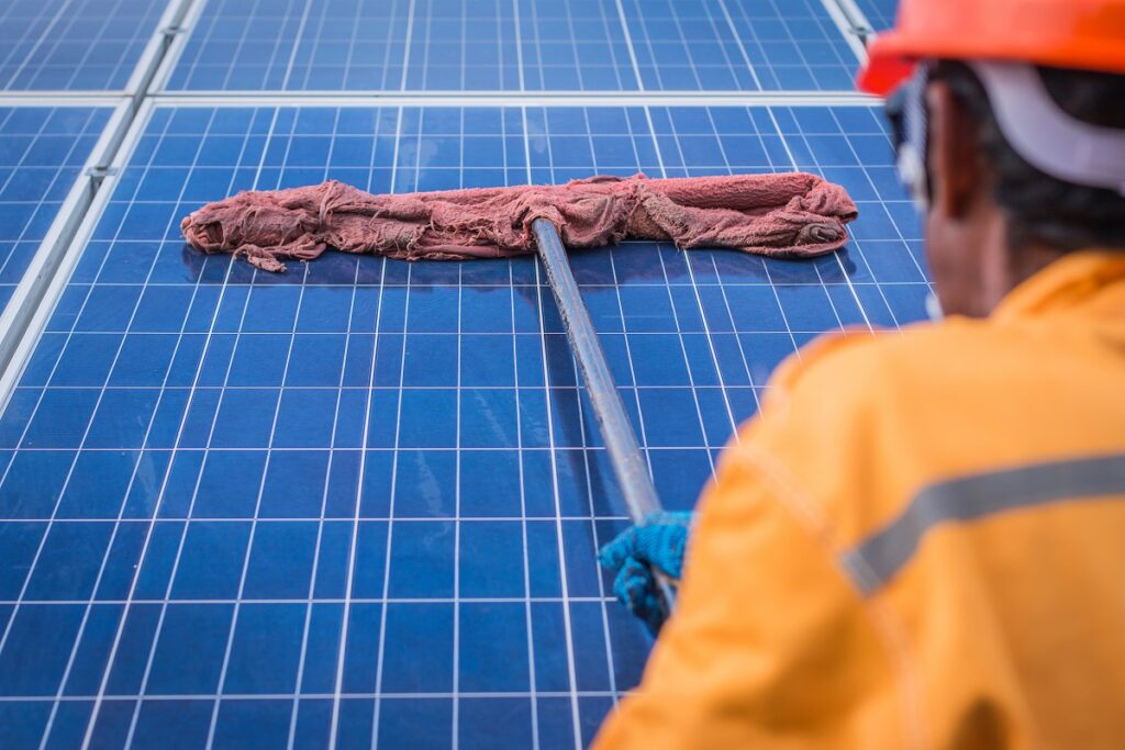 Professional cleaning solar panels with a mop