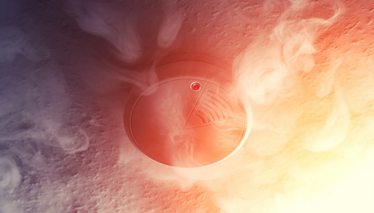 A smoke detector surrounded by smoke - fire safety tips