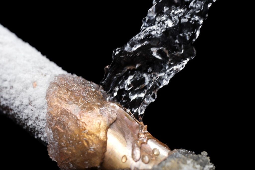 water being poured onto a frozen pipe