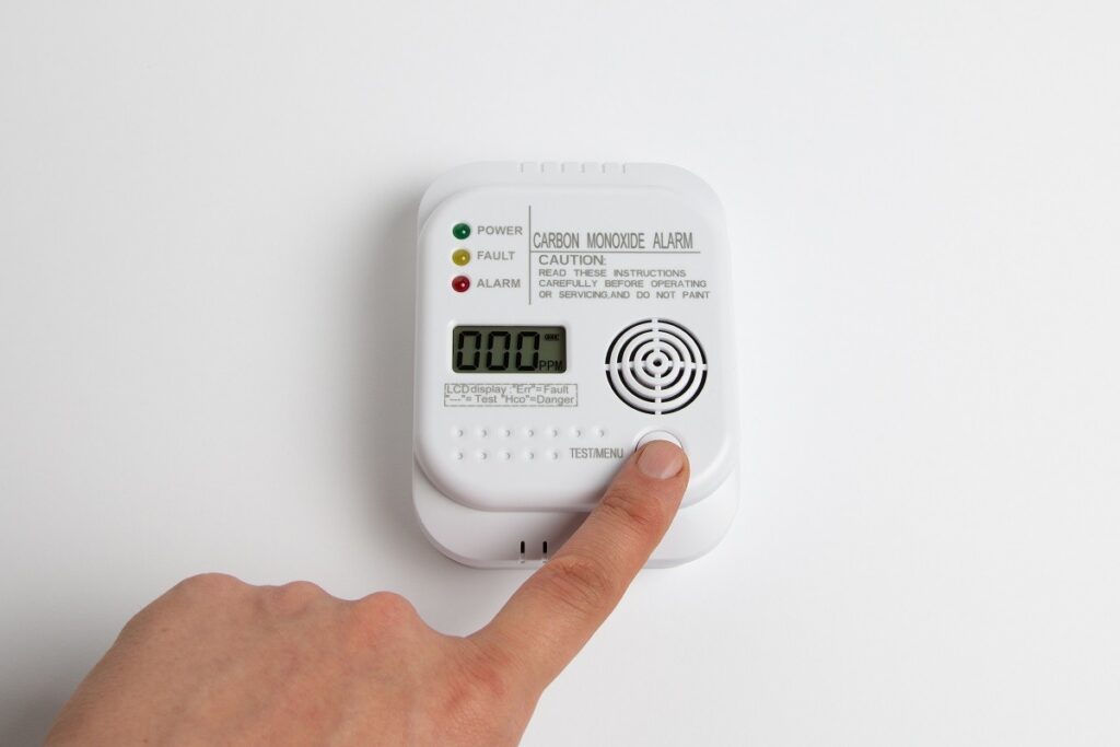 person testing CO detector