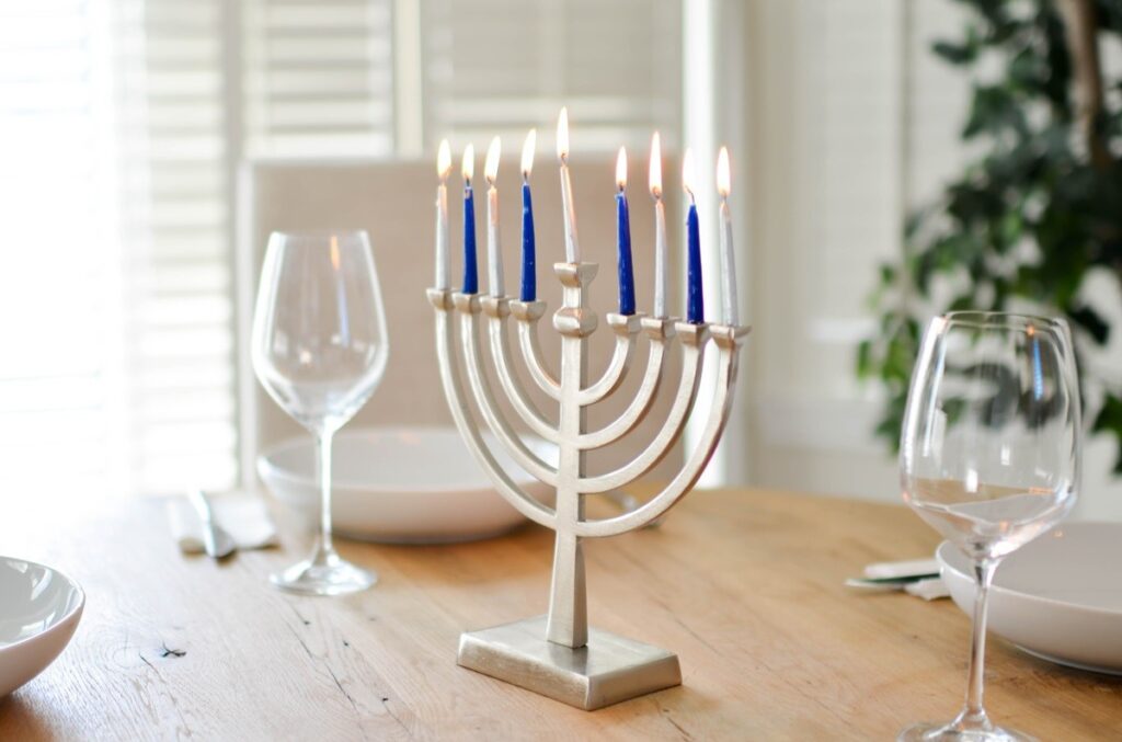 a menorah with blue and white candles lit on a table