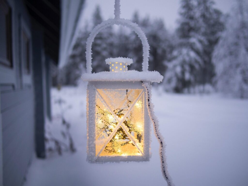 Electric lantern hanging outside in the snow