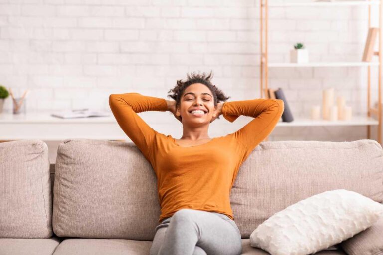 a woman smiling on a couch